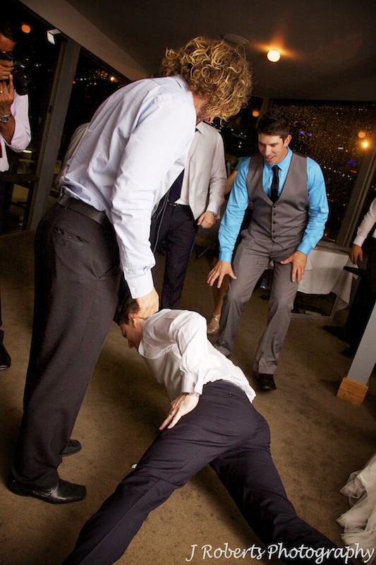 Groom dancing with crowd at wedding reception - wedding photography sydney